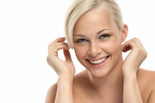 Image with beautiful smiling blonde girl on white background close-up